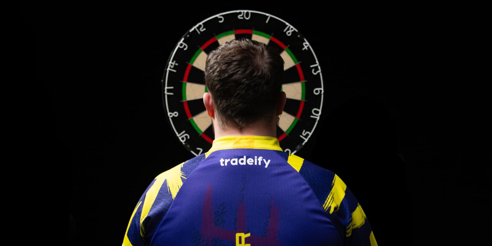 Luke Littler wearing Tradeify branded shirt